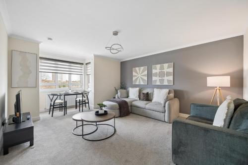 a living room with a couch and a table at Lees Apartment in Coatbridge