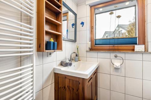 a bathroom with a sink and a window at Fewo am See in Olsberg