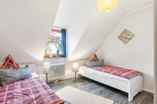 a living room with two beds and a window at Fewo am See in Olsberg