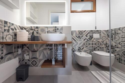 a bathroom with a sink and a toilet at Barrosu Studio Apartment in Orosei