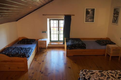 a room with two beds and a window at Gite De Cabrières in Compeyre