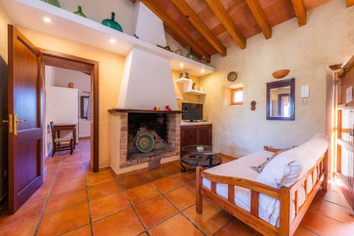 a living room with a fireplace and a couch at Finca Galardo in Son Servera