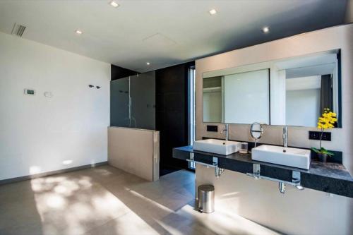 a bathroom with two sinks and a large mirror at Naturamar in Muro