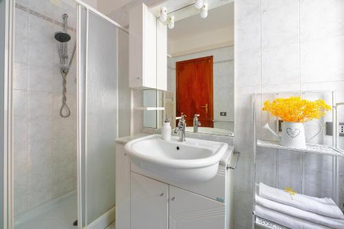 a white bathroom with a sink and a shower at Umbria Casavacanze Vista Panoramica in Montefranco