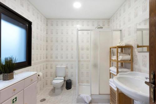 a bathroom with a toilet and a sink at Casa São Domingos 1 in Lousada