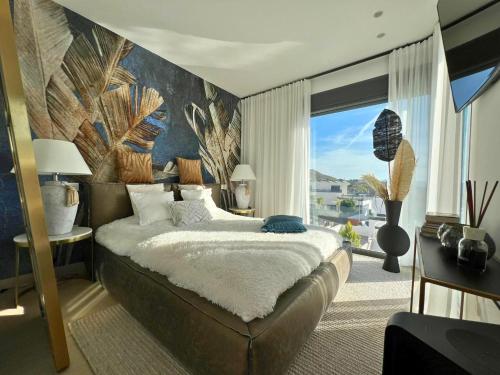 a bedroom with a large bed and a large window at Barcelona 11 in Finestrat