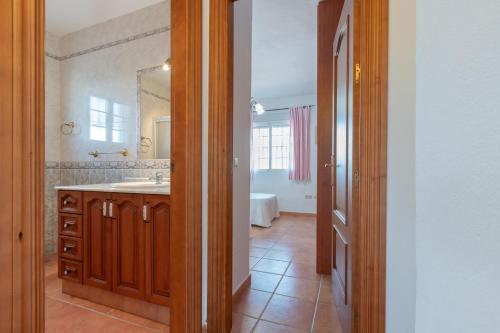 a bathroom with a sink and a mirror at Chalet andaluz Los Alberos in Coín
