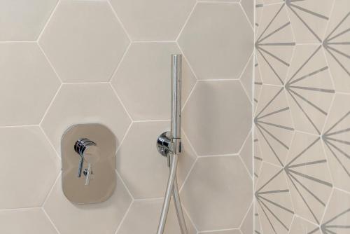a shower with a shower head in a bathroom at Dal Pernè in Volastra