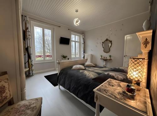 a bedroom with two beds and a table at Chambre D'hôte - Le Chalêt in Ygrande