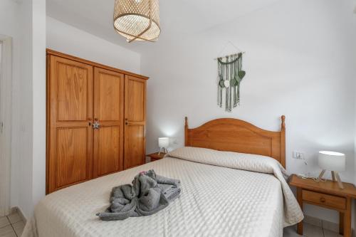 a bedroom with a bed with a towel on it at Jimaguas in Tamaduste