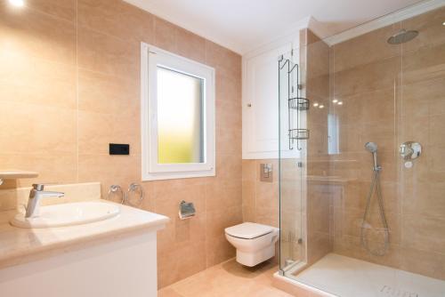 a bathroom with a shower and a toilet and a sink at Villa Flores in Marbella
