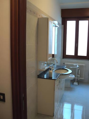 a bathroom with a sink and a toilet at Spacious Historic Apartment F1 in Gravedona
