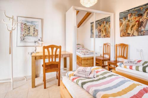 a room with two beds and a table and chairs at Casa amarilla del mar piso 3y4 in Villajoyosa
