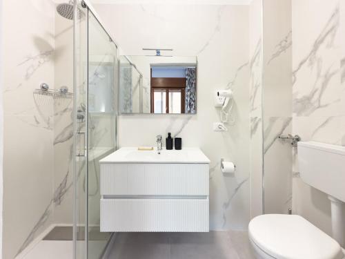 a white bathroom with a sink and a shower at Casa Bella Venezia 1 in Mestre