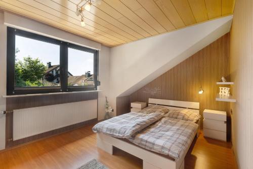 a bedroom with a bed and a window at Wohung zum Ausblick in Plettenberg