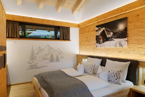 a bedroom with a bed and a picture on the wall at Alpenchalet 19 in Krün