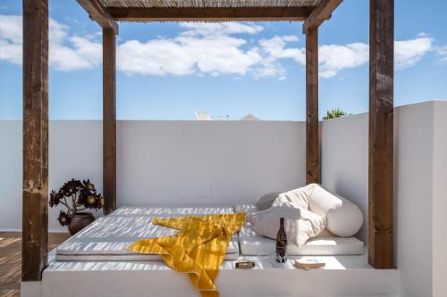 a bed in a room with a large window at Villa Princesa Faina in Tías