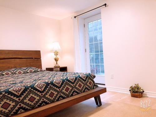 a bedroom with a bed and a window at Cozy 2bedroom Basement unit in Toronto