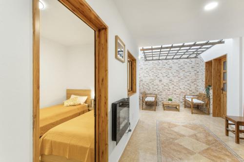 a bedroom with a bed and a living room at Casa Ñico in Artenara