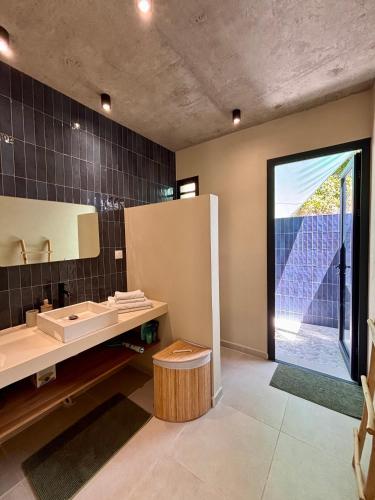 a bathroom with a sink and a mirror at CASA M Peaceful haven with pool in Îlet à Christophe