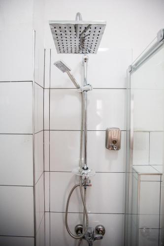 a shower with a shower head in a bathroom at 1826 Heritage House in Taksim