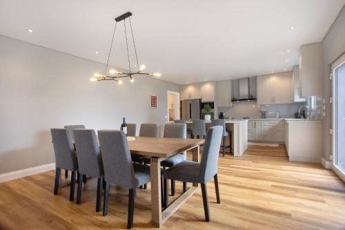 a dining room and kitchen with a table and chairs at Casa D'Avó - Family Coastal Escape in Casa Nova