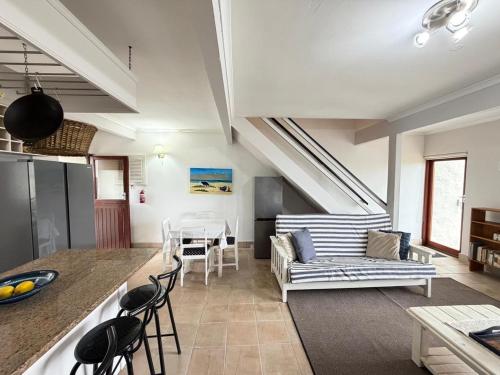 a living room with a couch and a table at LaMer No 5 in Stilbaai