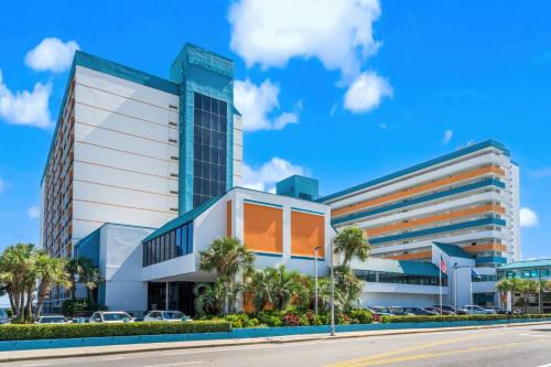 a building with palm trees in front of a street at Landmark Resort Ocean View Beach Pools Villa in Myrtle Beach