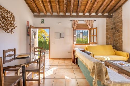 a living room with a couch and a table at Cortijo El Plantío Castril in Castril