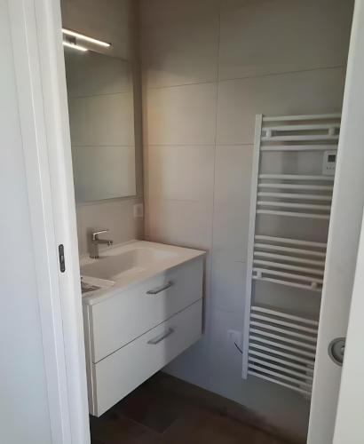 a bathroom with a sink and a mirror at Chambres D'hôtes - Noirmoutier in LʼÉpine