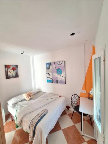 a bedroom with a bed and a desk in it at Ikigai House in Seville