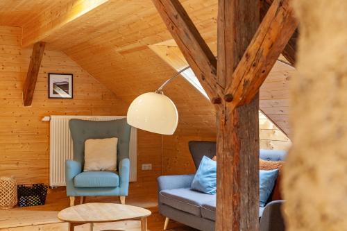 a living room with two chairs and a table at Penthouse im Bauernhaus in Kötschach