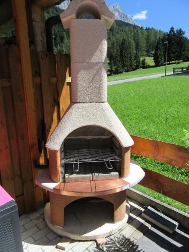 a wood fired pizza oven sitting on a patio at Alpen-Chalet Ehrwald in Ehrwald
