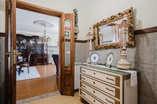 a bathroom with a sink and a mirror on a dresser at Quinta do Passal - Gondoriz in Gondoriz