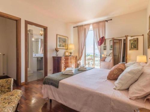 a bedroom with a large bed and a large window at Il Giardino Etrusco Bolsena in Bolsena
