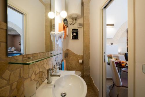 a bathroom with a sink and a mirror at Monolocale Delux Alithia in Muro Leccese