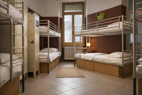 a dorm room with bunk beds and a window at Koala Hostel in Milan