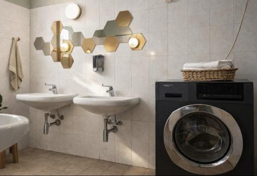 a bathroom with a washing machine and a sink at Koala Hostel in Milan