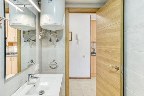 a bathroom with a sink and a mirror at San Enrique in L'Escala