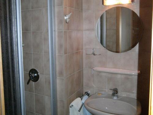 a bathroom with a toilet and a sink and a mirror at Gästehaus Fischerhäusle in Mitten