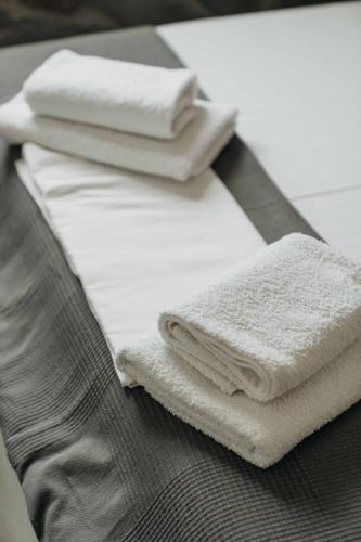 two white towels sitting on top of a table at House Avlomonas in Livadi