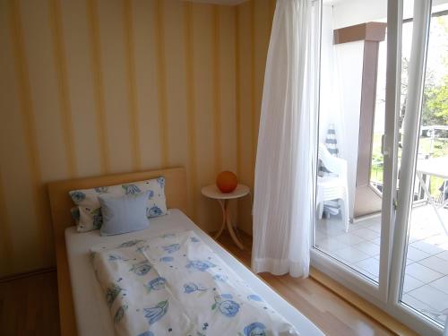 a bedroom with a bed and a sliding glass door at Gästehaus Fischerhäusle in Mitten