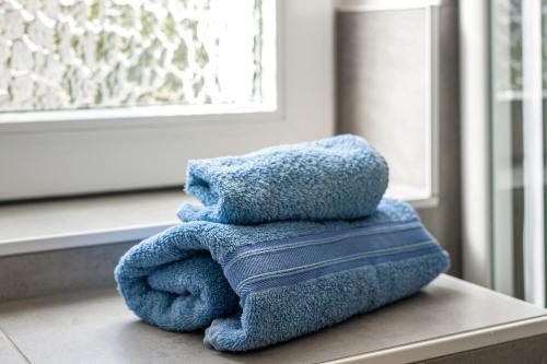 a pile of towels sitting on a table next to a window at Strandnahe Fewo 1 in Dierhagen