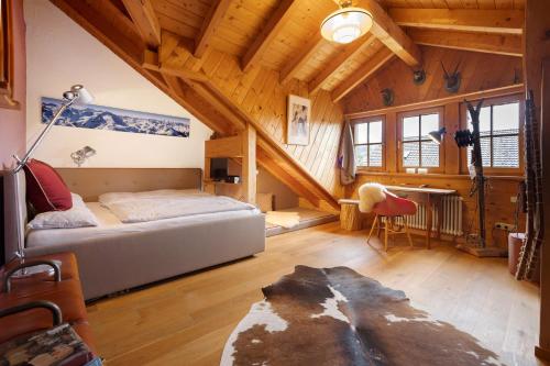a bedroom with a bed in a room with wooden ceilings at Ferienhaus Chalet Montfort in Sonthofen