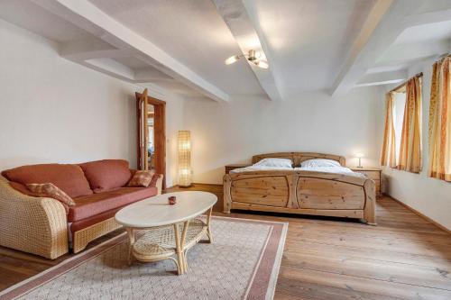 a living room with a couch and a table at Hof Hohe Eichen in Göhrde