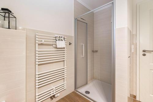 a shower with a glass door in a bathroom at Ferienhaus Christine in Breklum