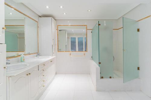 a bathroom with two sinks and a shower at Exclusive Villa El Messidor in Marbella