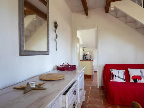 a kitchen with a wooden counter and a red chair at Gites Air Marin in Lannion