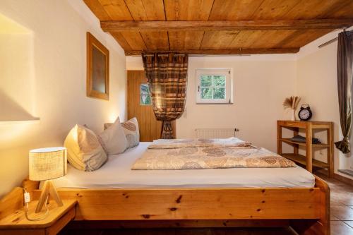 a bedroom with a wooden bed in a room at Schnyder Ranch in Ravensburg