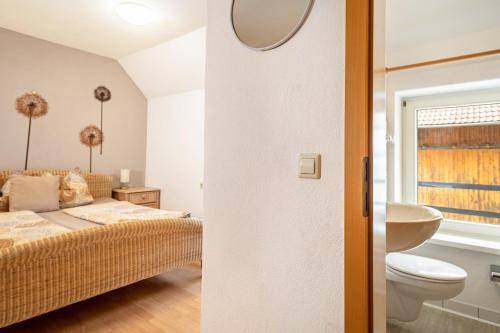 a bedroom with a bed and a sink and a toilet at Schnyder Ranch in Ravensburg